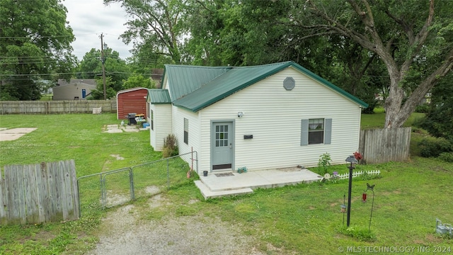 back of house featuring a patio area and a yard