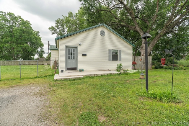 back of property featuring a yard