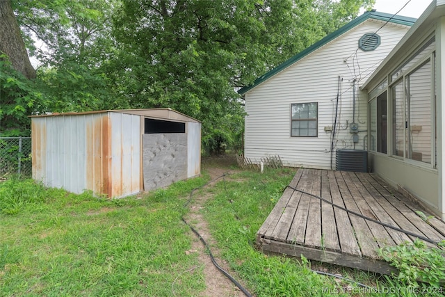 view of yard with a deck and a storage unit