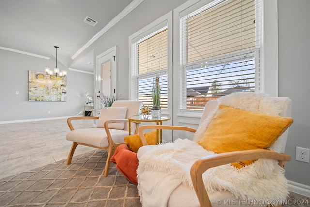 living area with a notable chandelier and crown molding