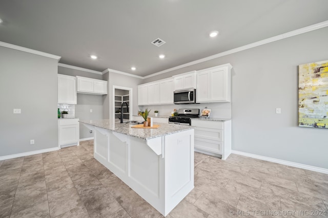 kitchen featuring light stone counters, light tile flooring, white cabinetry, an island with sink, and appliances with stainless steel finishes