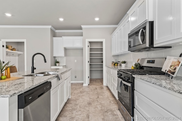 kitchen with appliances with stainless steel finishes, sink, light tile floors, and crown molding