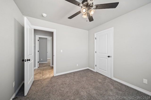 unfurnished bedroom with carpet and ceiling fan