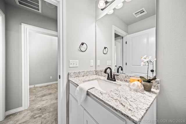 bathroom featuring tile floors and vanity