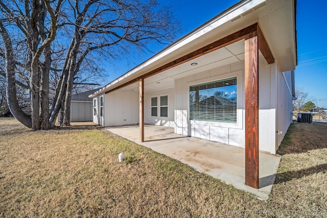 back of house featuring a lawn and a patio area