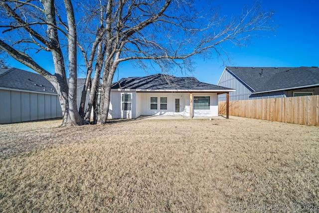 rear view of house with a lawn