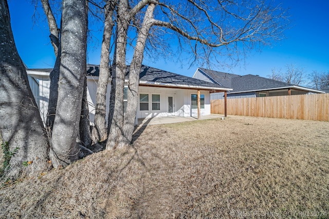 back of property featuring a yard and a patio