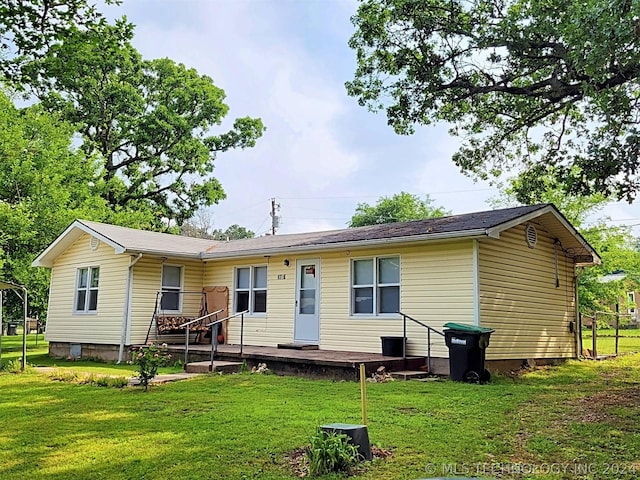 rear view of house with a lawn