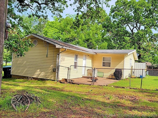 rear view of house with a yard