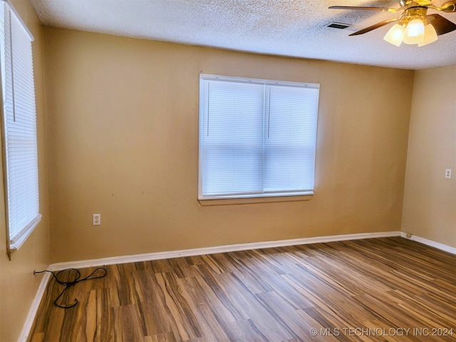 unfurnished room with hardwood / wood-style floors, a textured ceiling, plenty of natural light, and ceiling fan