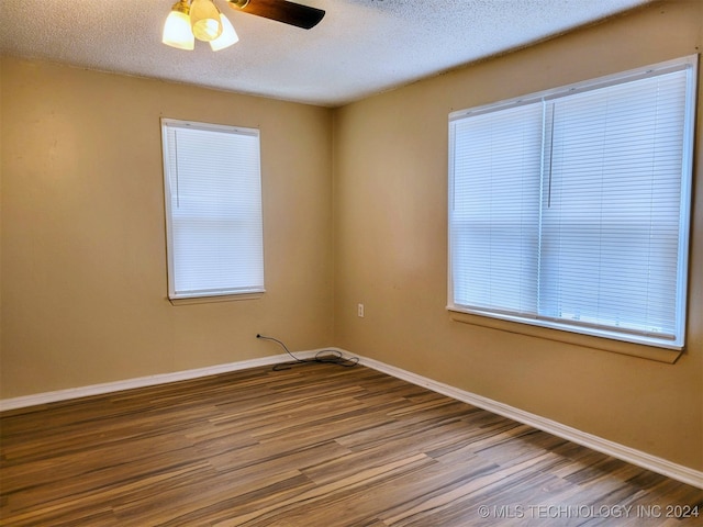 spare room featuring hardwood / wood-style floors, ceiling fan, and a textured ceiling