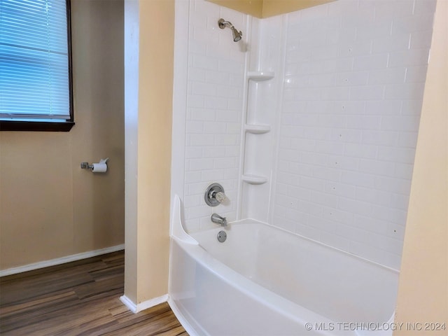 bathroom featuring shower / bathing tub combination and hardwood / wood-style floors