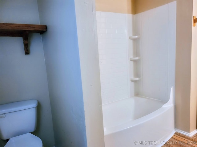 bathroom with toilet, shower / tub combination, and wood-type flooring