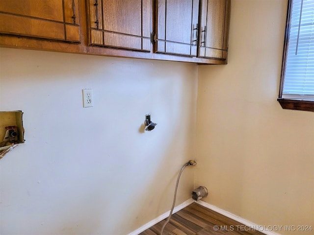 laundry area with hookup for a washing machine, dark hardwood / wood-style flooring, and cabinets