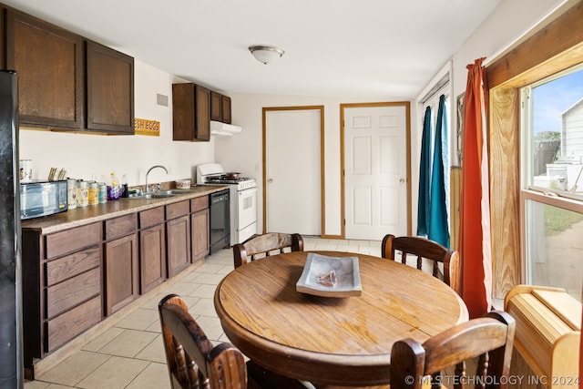 dining room with sink and light tile floors