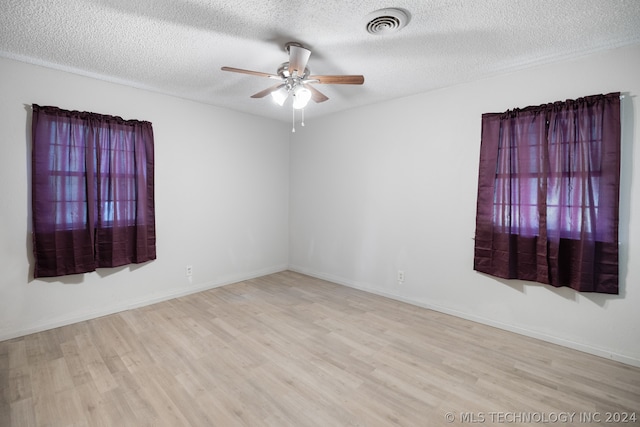 unfurnished room featuring light hardwood / wood-style floors, a textured ceiling, and ceiling fan