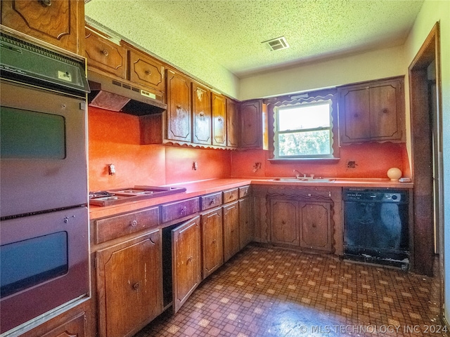 kitchen with a textured ceiling, dishwasher, stainless steel gas stovetop, sink, and double oven