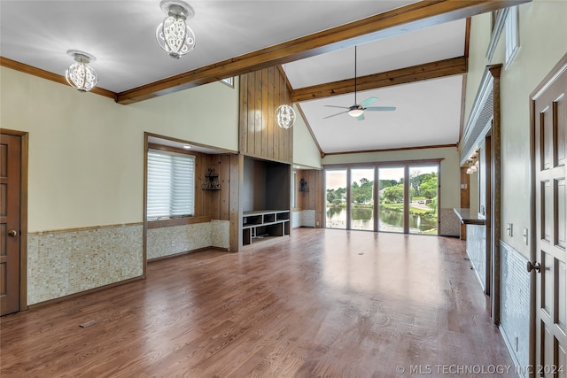 unfurnished living room featuring beam ceiling, high vaulted ceiling, hardwood / wood-style floors, ceiling fan with notable chandelier, and ornamental molding