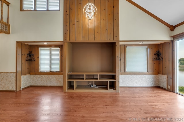 unfurnished living room with hardwood / wood-style floors, high vaulted ceiling, and a healthy amount of sunlight