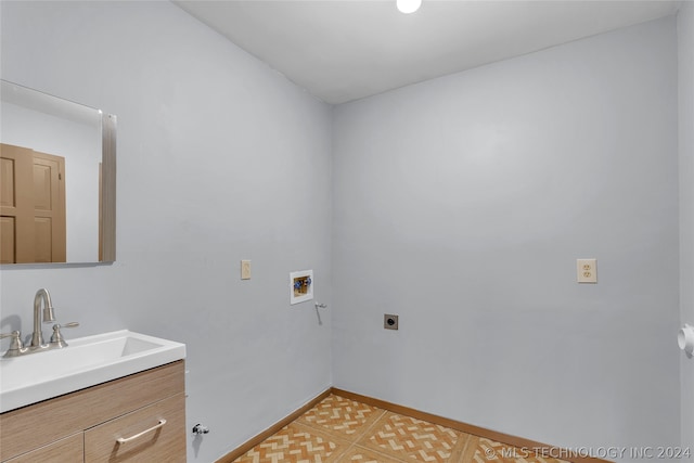 clothes washing area featuring hookup for a washing machine, light tile patterned floors, electric dryer hookup, and sink