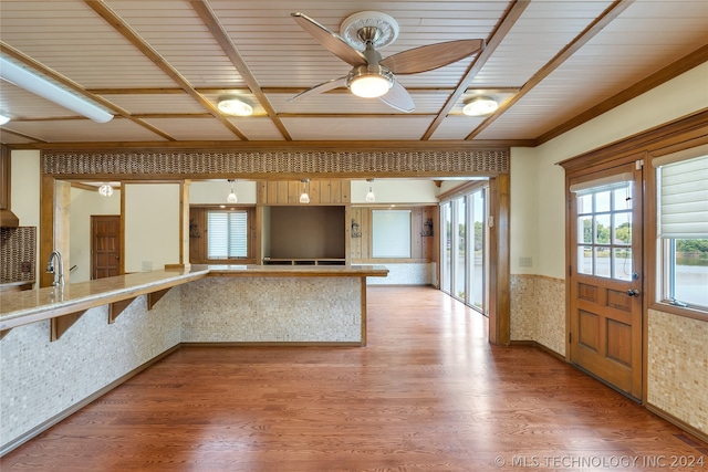 kitchen with kitchen peninsula, hardwood / wood-style floors, ceiling fan, and wooden ceiling