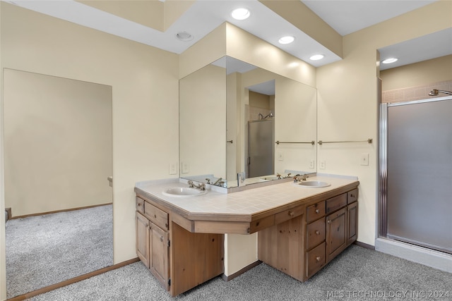 bathroom featuring vanity and a shower with shower door