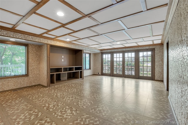 unfurnished living room with coffered ceiling