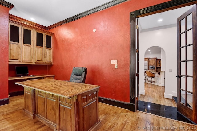 office featuring light wood-type flooring and ornamental molding