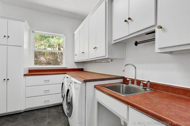 laundry room featuring washer and clothes dryer, cabinets, and sink