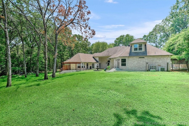 back of house with a yard, cooling unit, and a patio area