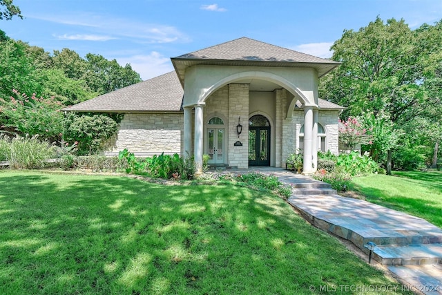 view of front of home featuring a front yard and french doors