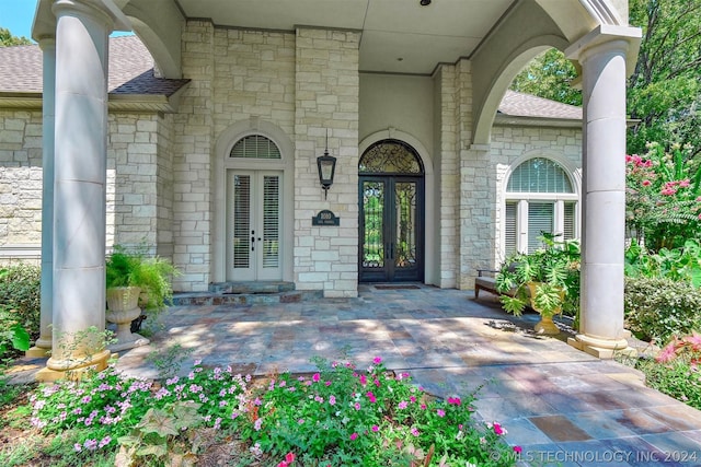 view of exterior entry featuring french doors