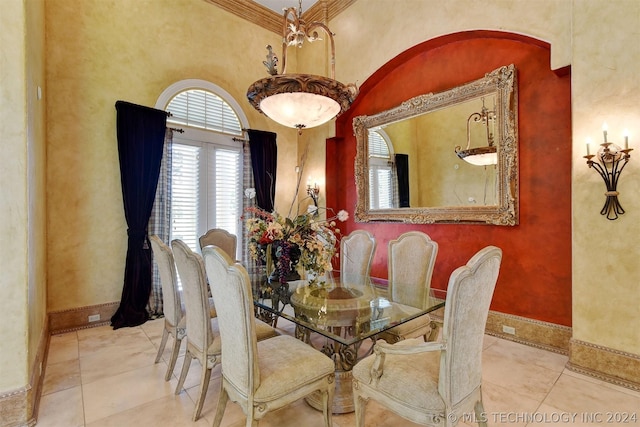 dining space with ornamental molding and light tile patterned floors