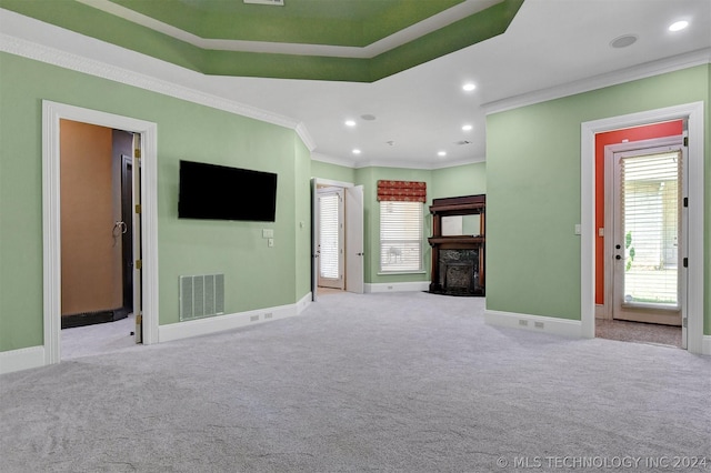 unfurnished living room featuring crown molding and light colored carpet