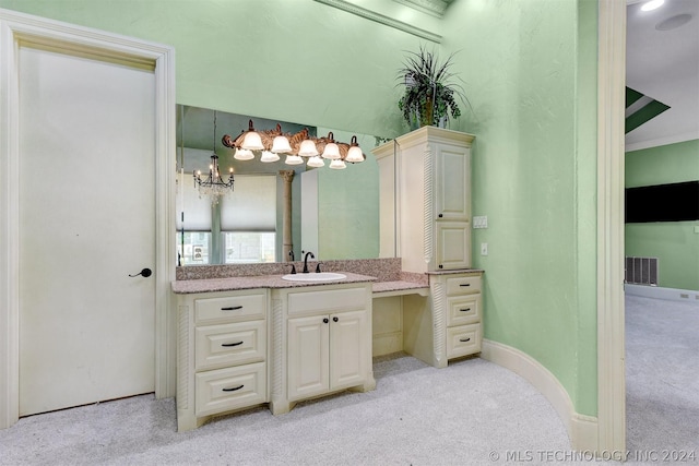 bathroom with vanity, an inviting chandelier, and ornamental molding