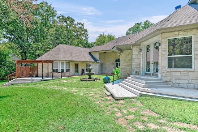 rear view of house with a yard and french doors