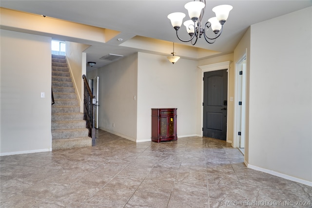 unfurnished room with a notable chandelier