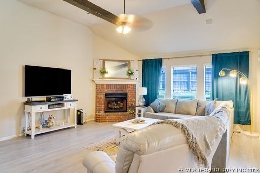 living room featuring a fireplace, lofted ceiling with beams, hardwood / wood-style flooring, and ceiling fan