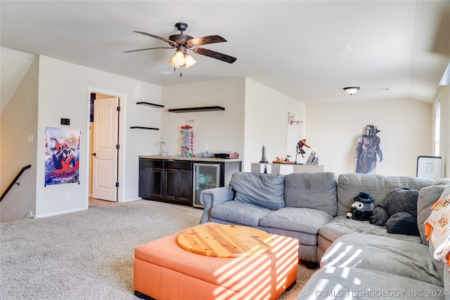 carpeted living room with bar area, wine cooler, and ceiling fan