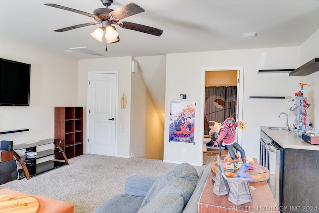 living room featuring ceiling fan, carpet, and wet bar