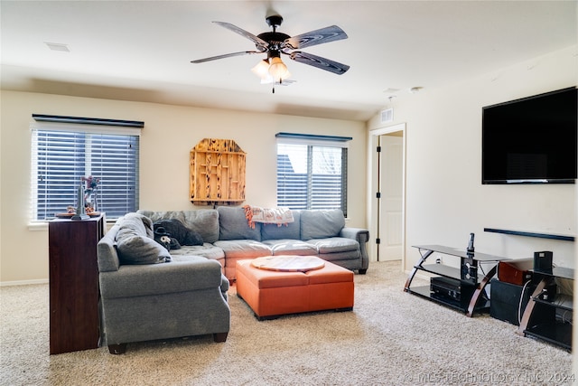 carpeted living room with ceiling fan