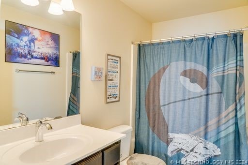 bathroom featuring vanity and toilet