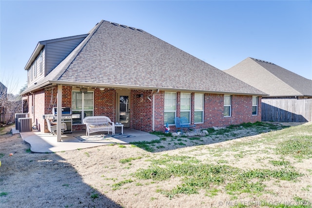 rear view of house with a patio and central AC unit