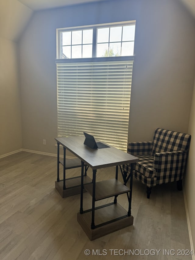 office area with hardwood / wood-style floors and lofted ceiling