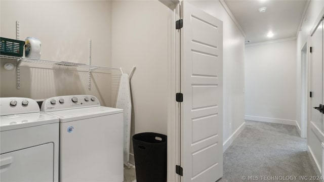 washroom featuring separate washer and dryer, light carpet, and crown molding