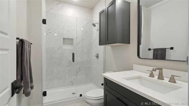 bathroom with vanity, toilet, and an enclosed shower