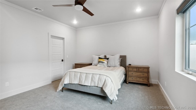 carpeted bedroom featuring multiple windows, crown molding, and ceiling fan