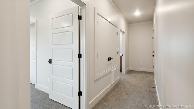 hall with light carpet and crown molding