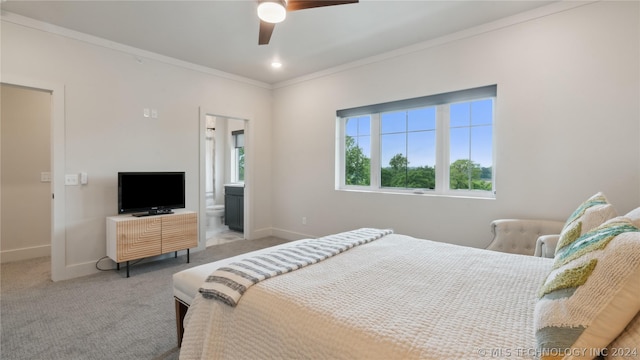 carpeted bedroom with ceiling fan, crown molding, and ensuite bathroom