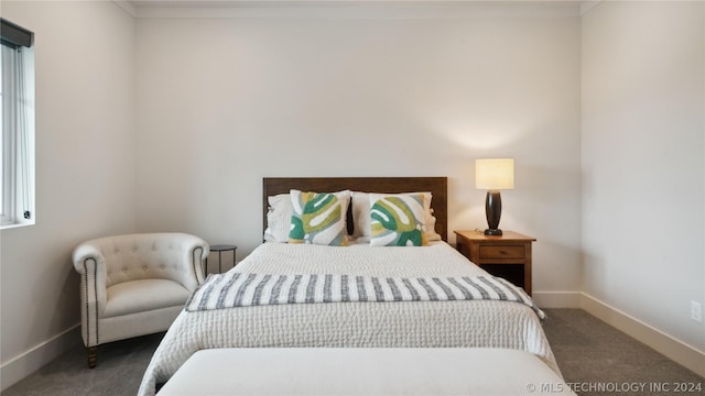 carpeted bedroom featuring ornamental molding and multiple windows